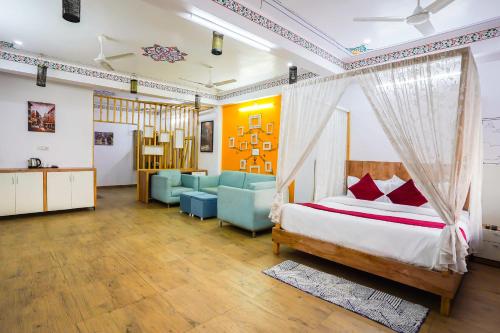 a bedroom with a bed and a living room at Saga by Lake in Udaipur