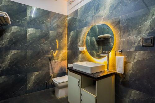 a bathroom with a sink and a mirror at Saga by Lake in Udaipur