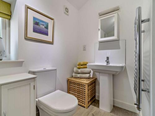 a white bathroom with a toilet and a sink at 2 Bed in Derby oc-76519 in Tutbury