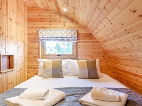 a bedroom with a bed in a wooden cabin at 2 Bed in Rhayader oc-90279 in Saint Harmon