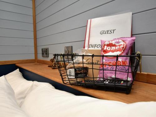 a shelf with a basket on top of a bed at 1 Bed in Rhayader oc-90278 in Saint Harmon