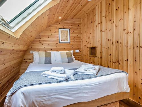 a bedroom with a bed in a log cabin at 2 Bed in Rhayader oc-90276 in Saint Harmon