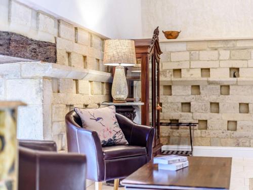a living room with a chair and a table at 3 Bed in Chippenham oc-77334 in Chippenham