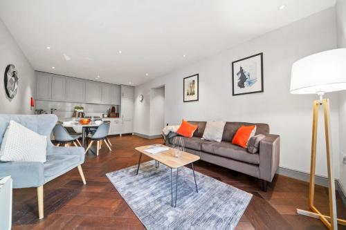 a living room with a couch and a table at 2 Bed Lux Apartments near Central London FREE WIFI by City Stay Aparts London in London