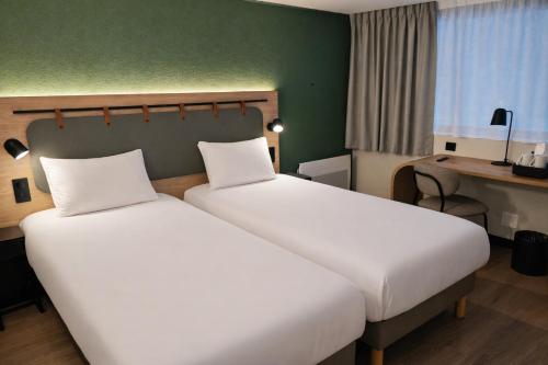 a hotel room with two beds and a desk at Campanile Lille Sud - Douai Cuincy in Cuincy