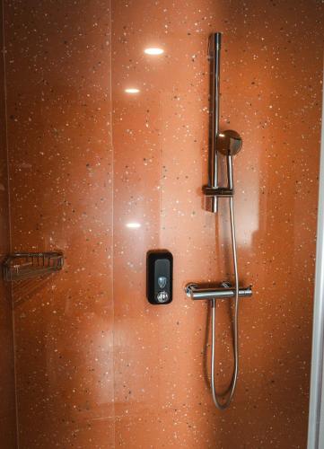 a shower stall with a phone on the wall at Bed and Breakfast Portal in Ljubljana
