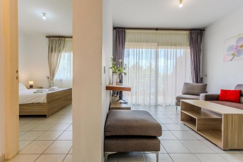 a hotel room with a bed and a couch at Resitour - Limnaria Gardens in Paphos