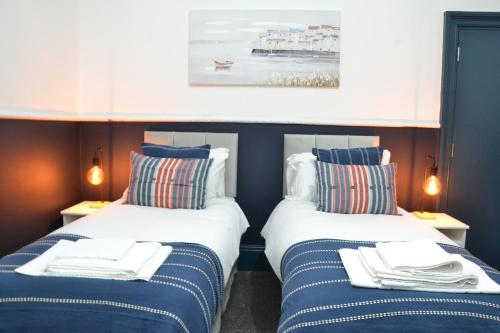 two beds sitting next to each other in a room at Manchester Ashton Suites in Ashton under Lyne