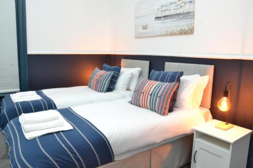 a bedroom with two beds with pillows at Manchester Ashton Suites in Ashton under Lyne