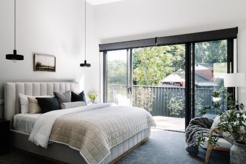 a bedroom with a bed and a large window at Aspen Lodge Bright in Bright