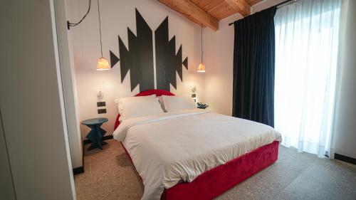 a bedroom with a large bed and a large window at Hotel Bazaar Center in Tirana