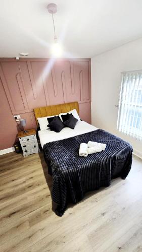 a bedroom with a large bed with two towels on it at City Centre 2 Bed 2 Bath 5 guest with Cheapest overnight Car park Entrepreneur Stays in Leicester