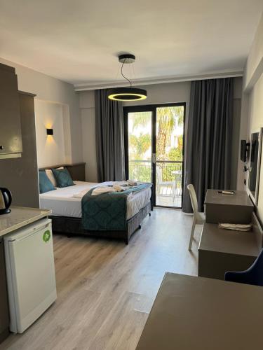 a hotel room with a bed and a balcony at Orange Garden Aparts & Hotel THE NORDIC in Kemer