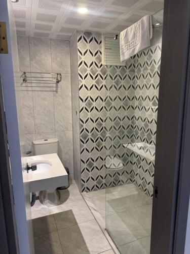 a bathroom with a white sink and a shower at Orange Garden Aparts & Hotel THE NORDIC in Kemer