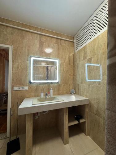 a bathroom with a sink and a mirror at Euro Panzio in Debrecen