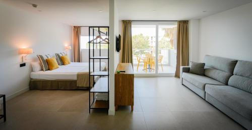 a living room with a bed and a couch at Apartamentos Vistasol in Magaluf