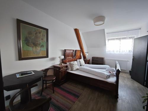a living room with a couch and a table and a bed at Penzion U Švarců in Zduchovice