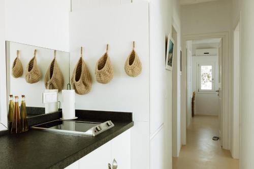 a kitchen with white walls and a counter with a sink at Villa Riza in Apróvaton