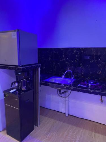 a kitchen with a purple counter and a sink at HOUSEBOAT AFFA grup in Karanganyar