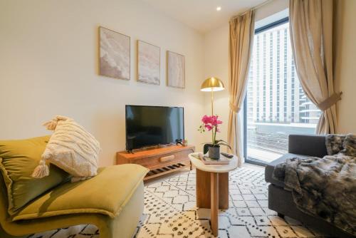 a living room with a couch and a tv at Executive 1 Bed Apartment in Central London near Victoria Station FREE WIFI by City Stay Aparts London in London