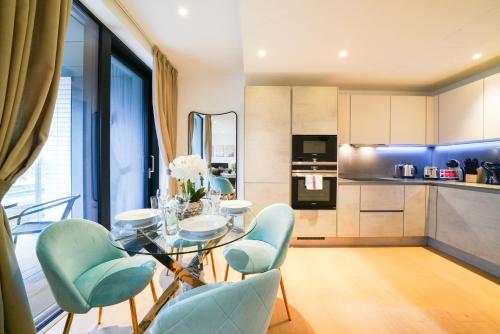 a kitchen and dining room with a glass table and chairs at Executive 1 Bed Apartment in Central London near Victoria Station FREE WIFI by City Stay Aparts London in London
