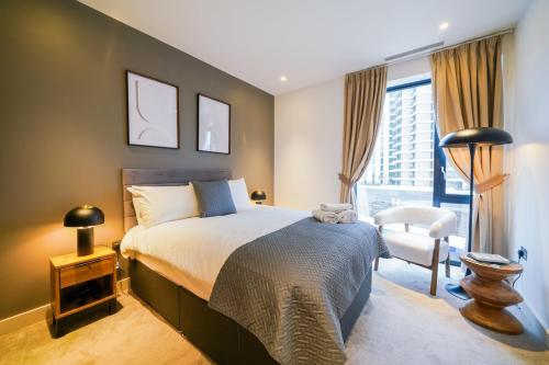 a bedroom with a bed and a chair and a window at Executive 1 Bed Apartment in Central London near Victoria Station FREE WIFI by City Stay Aparts London in London
