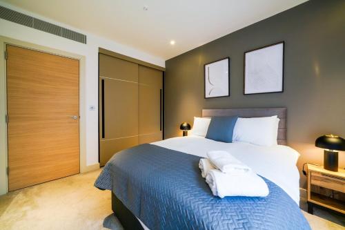 a bedroom with a large bed with towels on it at Executive 1 Bed Apartment in Central London near Victoria Station FREE WIFI by City Stay Aparts London in London