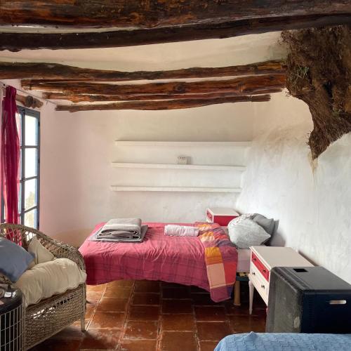 a bedroom with a bed in the corner of a room at Los Albergues in Pitres
