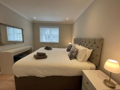 a bedroom with a large bed with pillows on it at 1 The Maltings, Crail in Crail