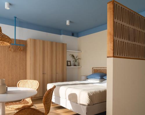 a bedroom with a bed and a table and chairs at Złota 34 Karwia in Karwia
