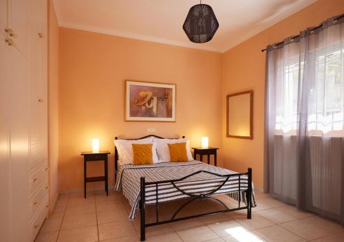 a bedroom with a bed and two candles on two tables at Modern retreat near Ancient Olympia and sandy beach in Káto Samikón