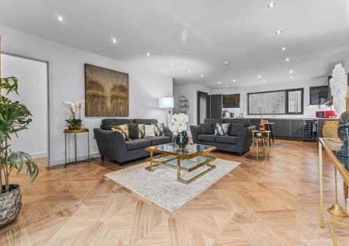 a living room with two couches and a table at Super King Penthouse Minutes from Arndale Centre - Pass the Keys in Manchester
