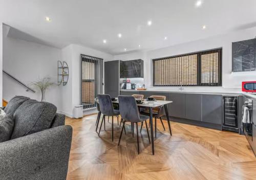 a kitchen and living room with a table and chairs at Super King Penthouse Minutes from Arndale Centre - Pass the Keys in Manchester