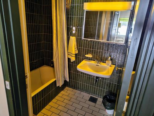 a small bathroom with a sink and a shower at Sæbygaard Estate Kalundborg in Ruds-Vedby