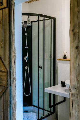 a glass shower in a bathroom with a sink at Seenswert - ein Wohlfühlort, in dem ALLE herzlich willkommen sind in Pähl