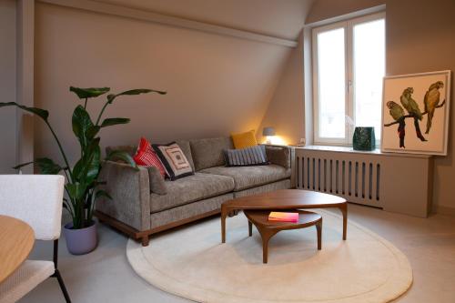 a living room with a couch and a table at The Painters Loft sleeping among the art in Haarlem