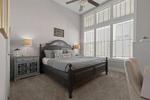 a bedroom with a bed and a large window at Sea Haven At Prominence in Watersound Beach