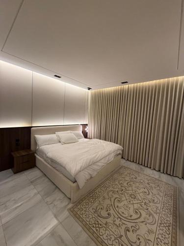 a bedroom with a large bed and a rug at فيلا شاليه ذا ويسس in Taif