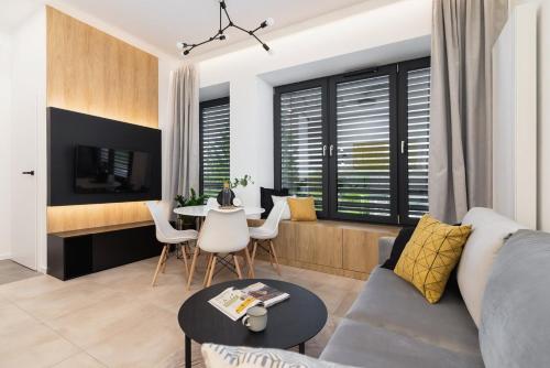 a living room with a couch and a table at Apartamenty EN Zator in Podolsze