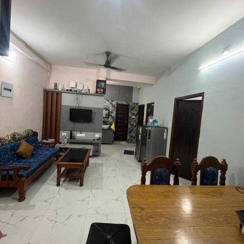 a living room with a couch and a tv at The Human Nest Coliving in Bhubaneshwar