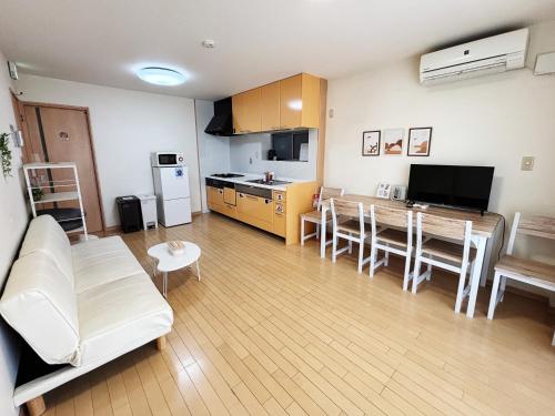 a living room with a white couch and a table at 時旅ー大正 in Osaka
