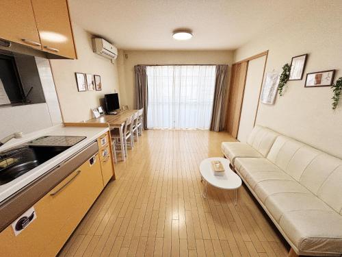 a kitchen and living room with a couch and a table at 時旅ー大正 in Osaka