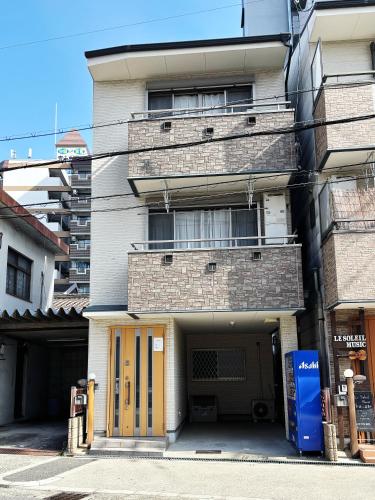 an apartment building with yellow doors in front of it at 時旅ー大正 in Osaka