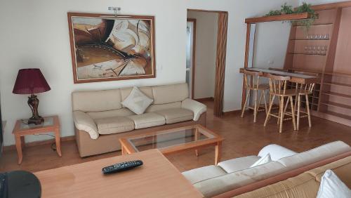 a living room with a couch and a table at Spacious 4-Bedroom Chalet - Ski and Summer in Kfardebian