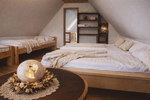 a bedroom with two beds and a coffee table at Chata pod kopcom in Žarnovica