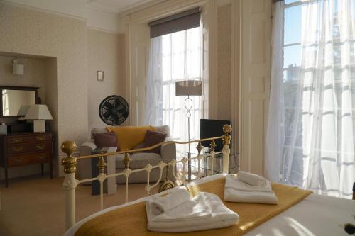 a hotel room with a bed and a living room at Castle House Guest House in Dover