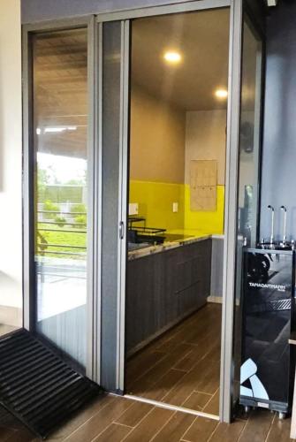 a kitchen with a sliding glass door with a counter at Palisade Garden in Ấp Thiện Sơn