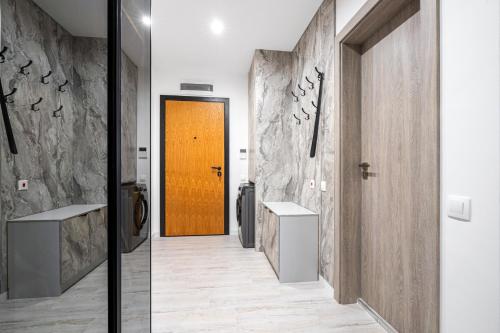 a hallway with a wooden door and a hallway with a hallway at Plovdiv Luxury 1BR * Free Parking * Rowing Base in Plovdiv
