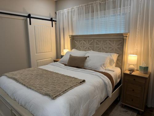 a bedroom with a large white bed with a window at Beach House with Breathtaking Sunsets - Perfect for Couples and Families! in Bolivar Peninsula