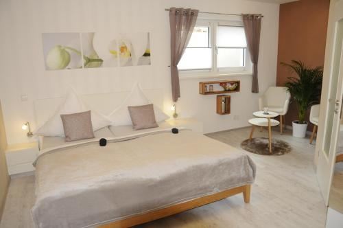 a bedroom with a large bed and a window at Pension Dietrich in Dobel